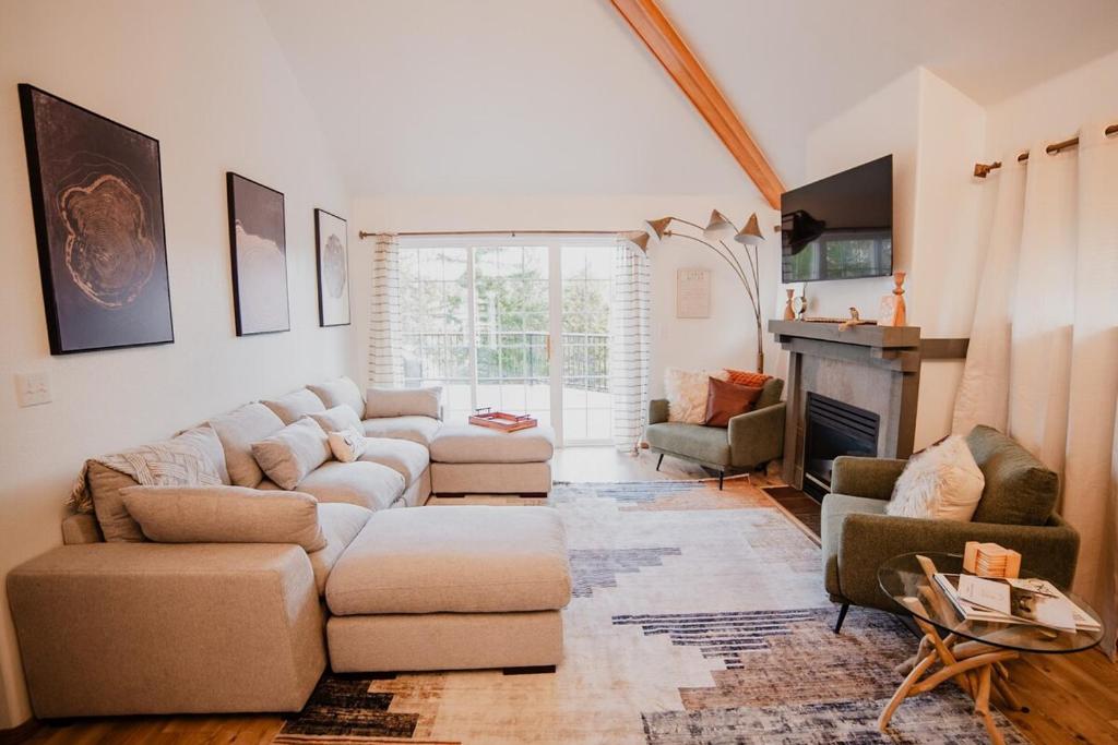 a living room with a couch and chairs and a fireplace at Sage & Pine Modern Townhome in Klamath Falls