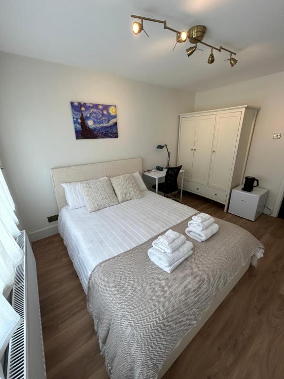 a bedroom with a bed with towels on it at King Room in Windsor with Private Bathroom in Windsor