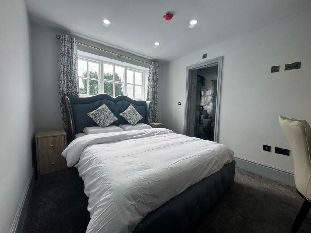a bedroom with a large bed and a window at The Old Court House in Kingswinford