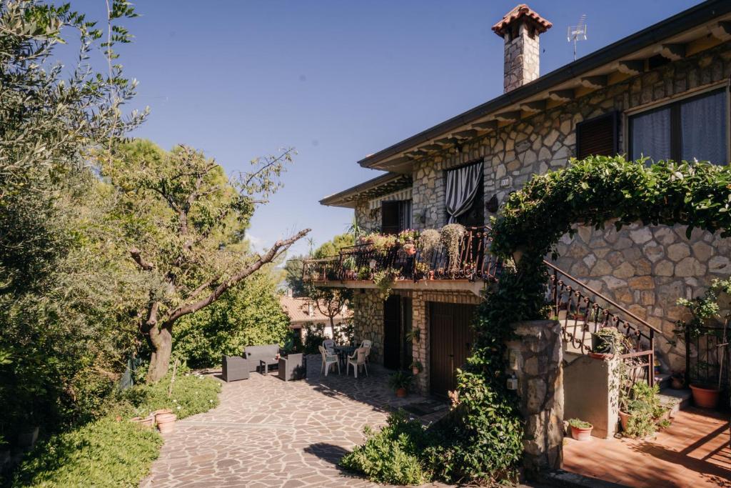 a stone house with a balcony on the side of it at Le Margherite in Castiglione del Lago