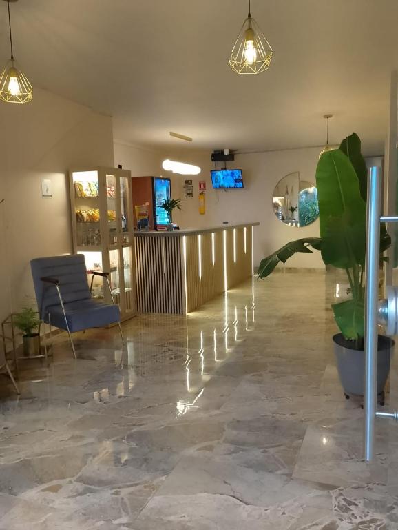 a lobby with a potted plant in a room at History Center Hotel in Medellín
