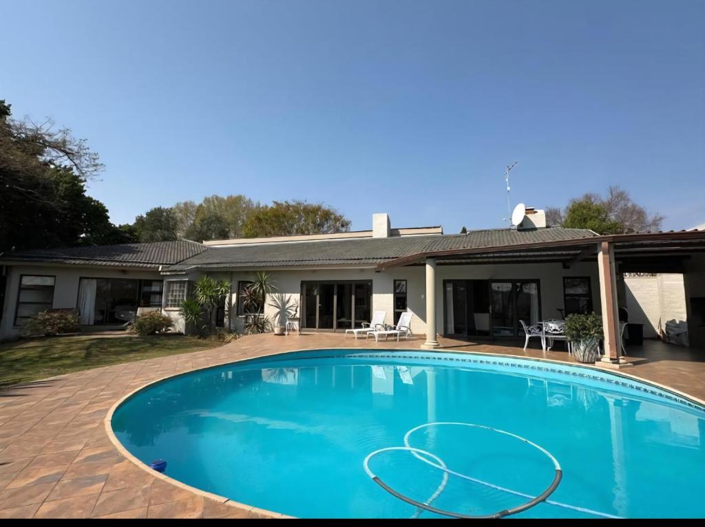 a swimming pool in front of a house at Stone Trading Pty Ltd in Durban