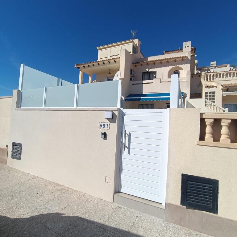 a white house with a white garage door at La casa de Lucas in Orihuela Costa