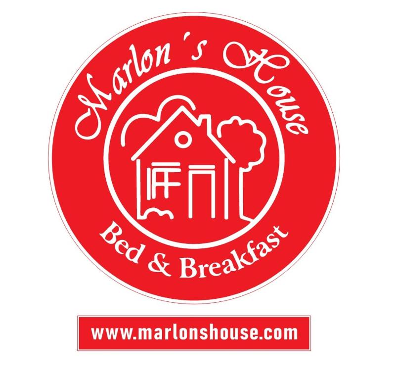 a red and white sticker of a red and white house at Marlon's INN Cusco II in San Antonio