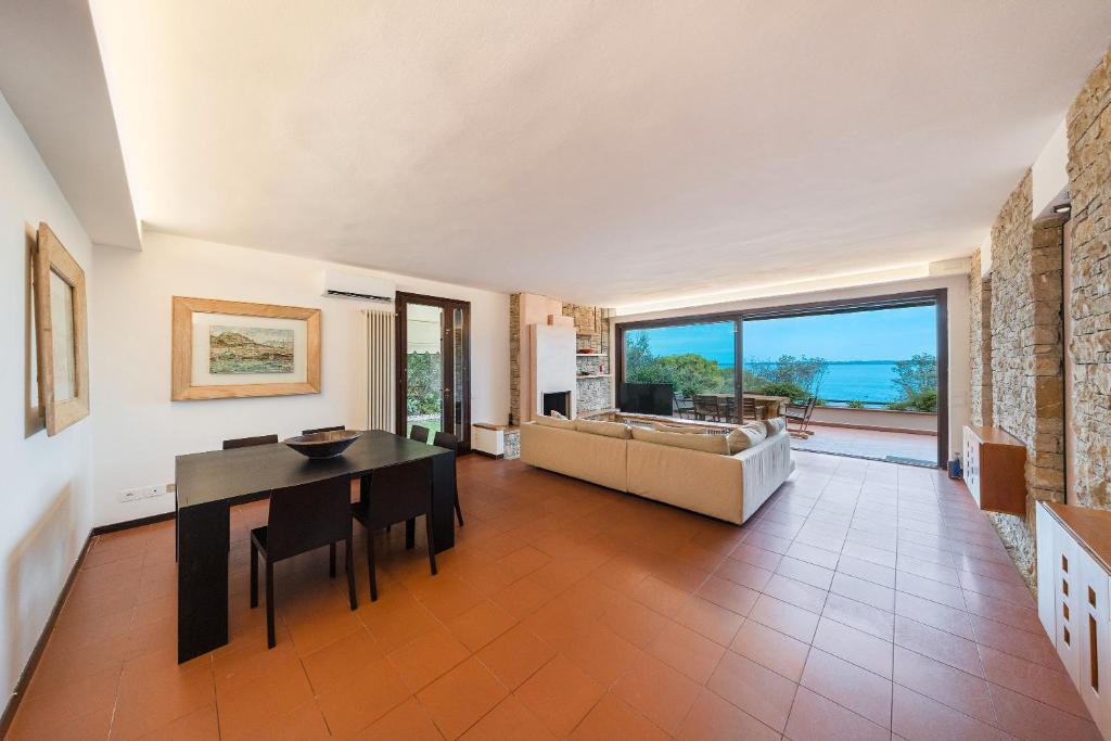 ein Wohnzimmer mit Tisch und Couch in der Unterkunft La Baia2, Lake View, Quiet in Padenghe sul Garda