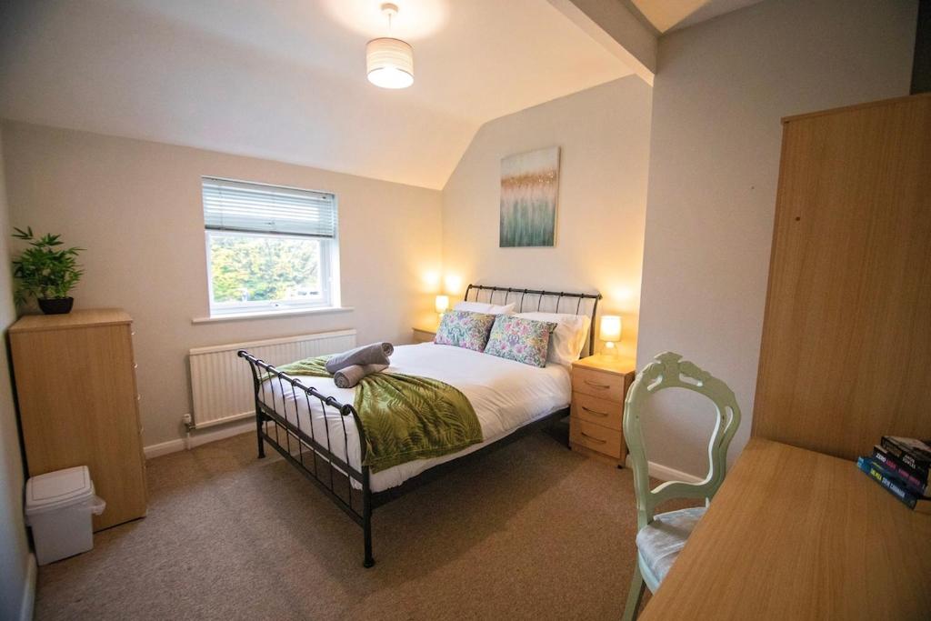 een slaapkamer met een bed met een teddybeer erop bij Stanmore House - Winchester 