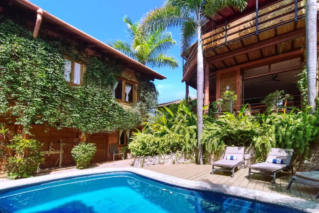 a villa with a swimming pool in front of a house at Hotel Casa San Pancho in San Francisco