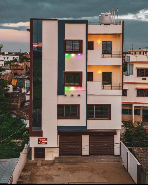 a tall white building with a balcony at Hotel Purvanchal in Katihār
