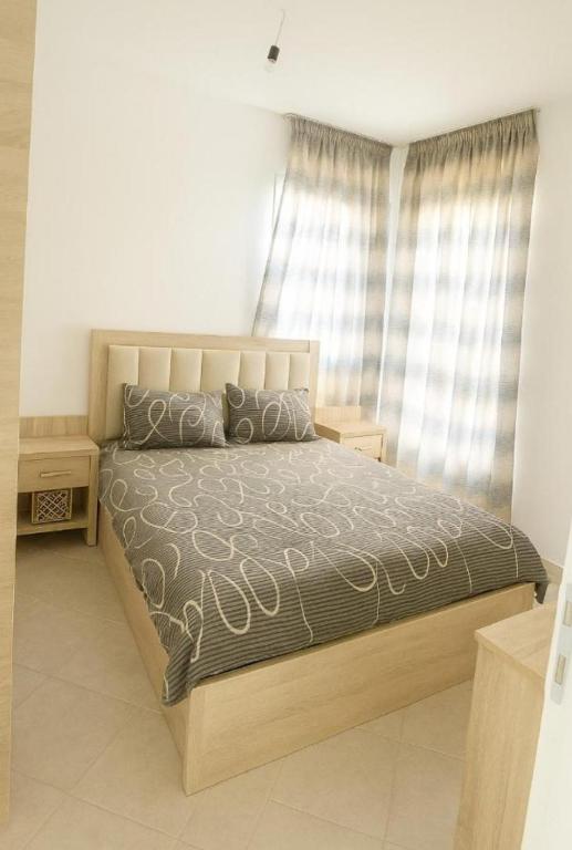 a bedroom with a large bed with a large window at Le paradis in Martil