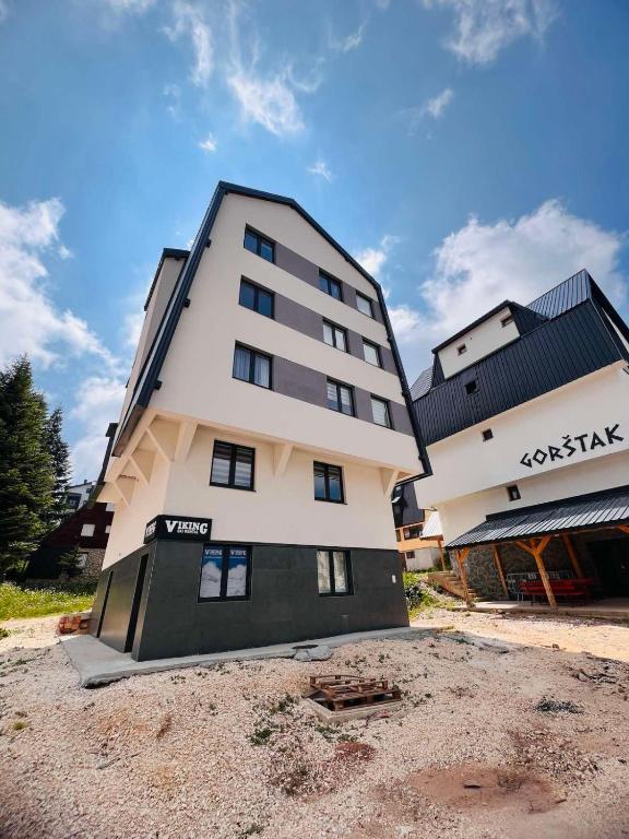 un grand bâtiment au milieu d'une cour en terre battue dans l'établissement Jahorina, Bosna i Hercegovina - Moja planina, à Trnovo