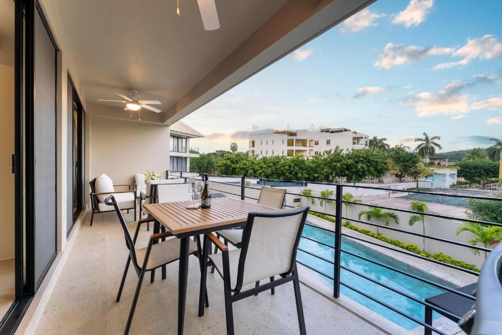 a balcony with a table and chairs and a view of the water at 3062 - Solana C203 in Cedro