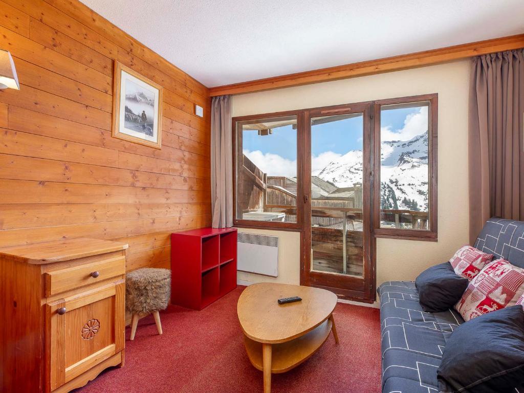a living room with a couch and a table and a window at Studio 4 pers à Avoriaz, au calme avec balcon - FR-1-314-314 in Avoriaz