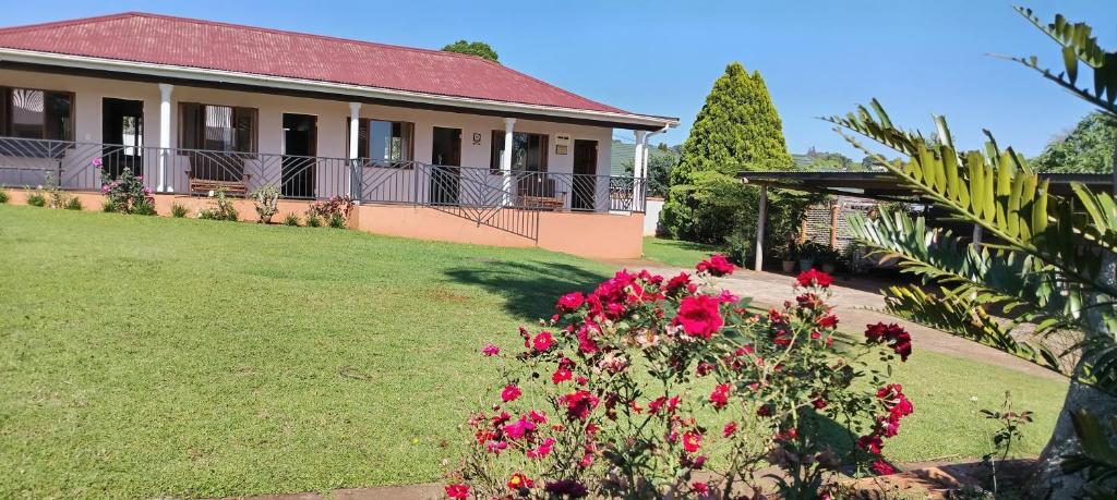 a house with pink flowers in the yard at Leuchars Guest House in Greytown