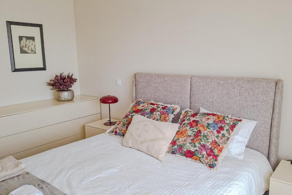 a bedroom with a bed with two pillows on it at Sea & City Escape in Matosinhos