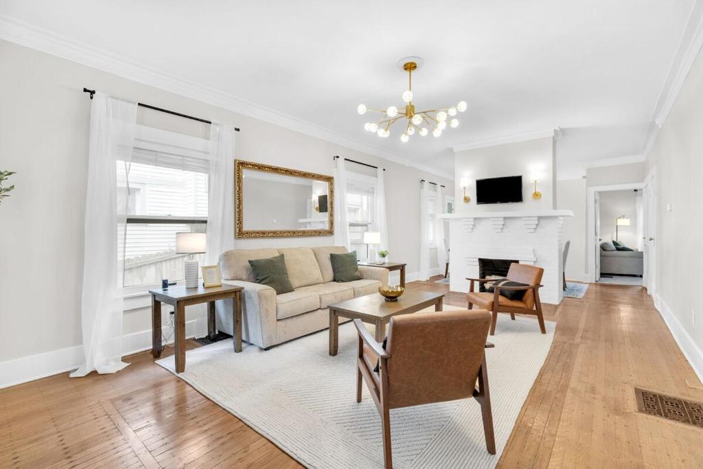 a living room with a couch and a table at MidTown Cozy Cottage in Indianapolis