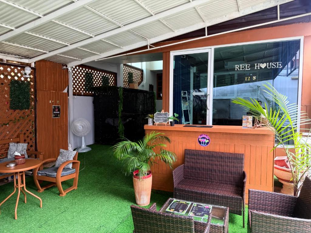 a patio with a table and chairs and a table and a table and chairs at Ree House- Sukhumvit 23 in Bangkok