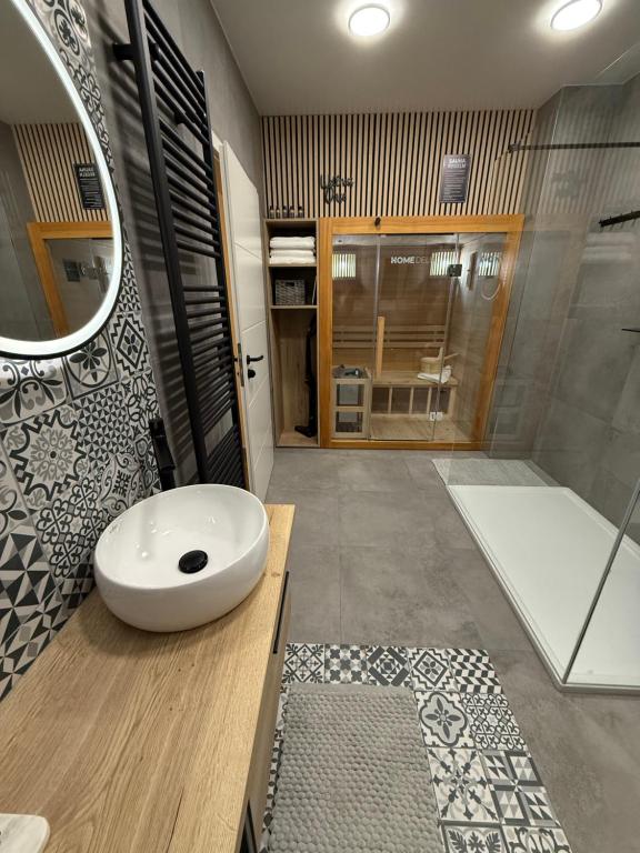 a bathroom with a white sink and a shower at Pro Home Mara private Sauna in Bad Oeynhausen