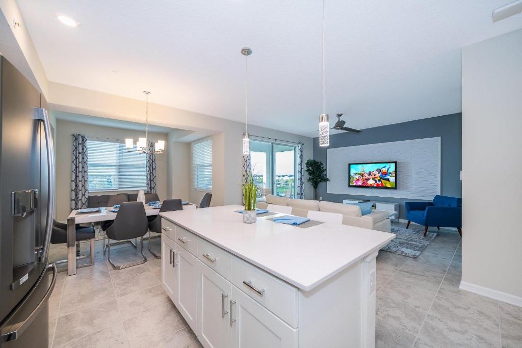 a kitchen and living room with a kitchen and a dining room at 3151-307BE STOREY LAKE, CONDO 2/2 LAKE VIEW in Kissimmee