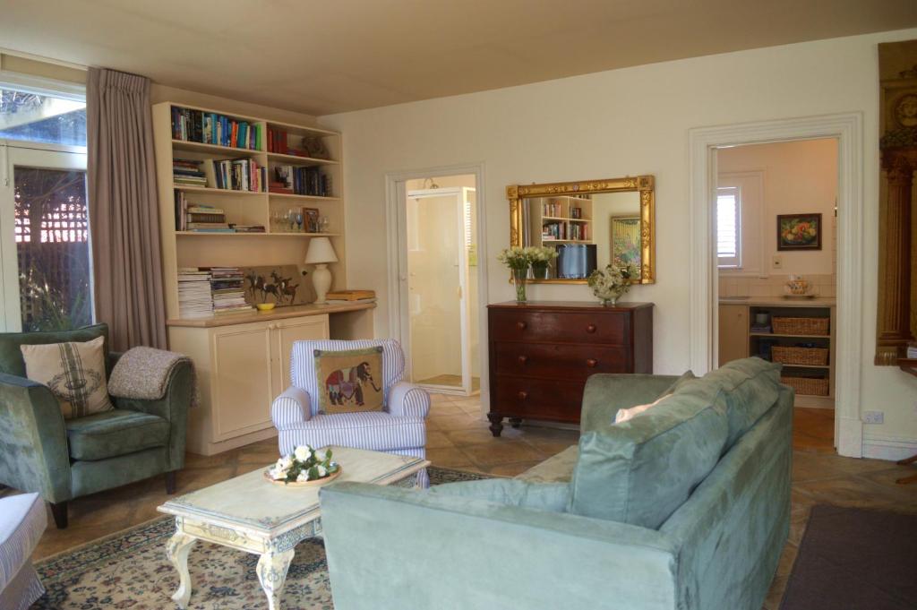 a living room with two chairs and a couch at Athelney Cottage Bed and Breakfast in Adelaide