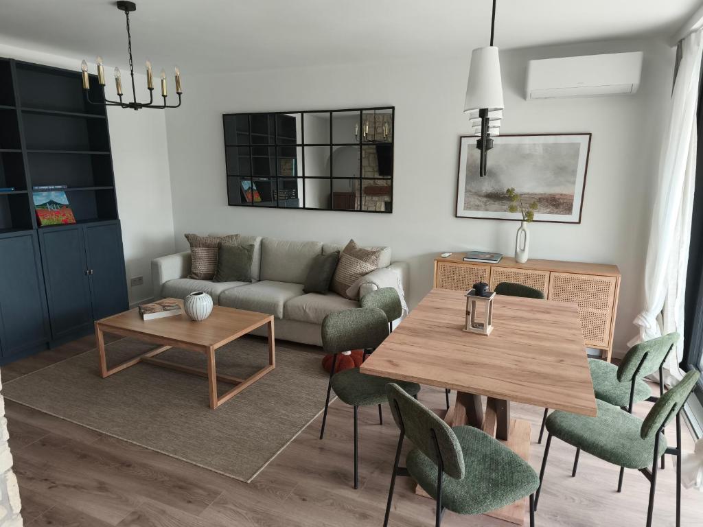 a living room with a couch and a table and chairs at Gödöllő Country Home in Gödöllő