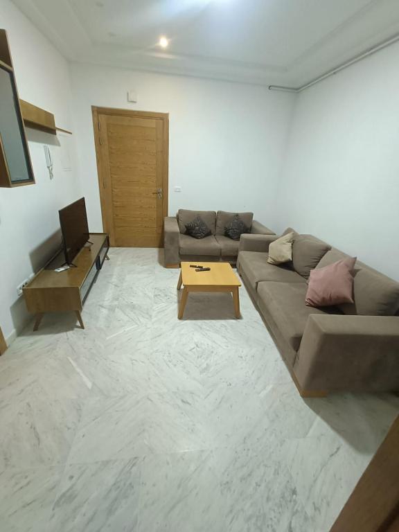 a living room with a couch and a coffee table at S2 JDC jardin de carthage in Tunis