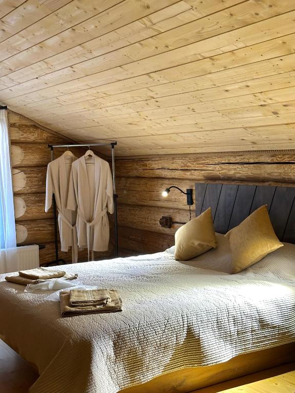a bedroom with a bed with a wooden ceiling at Stone & Forest Spa in Ternopil