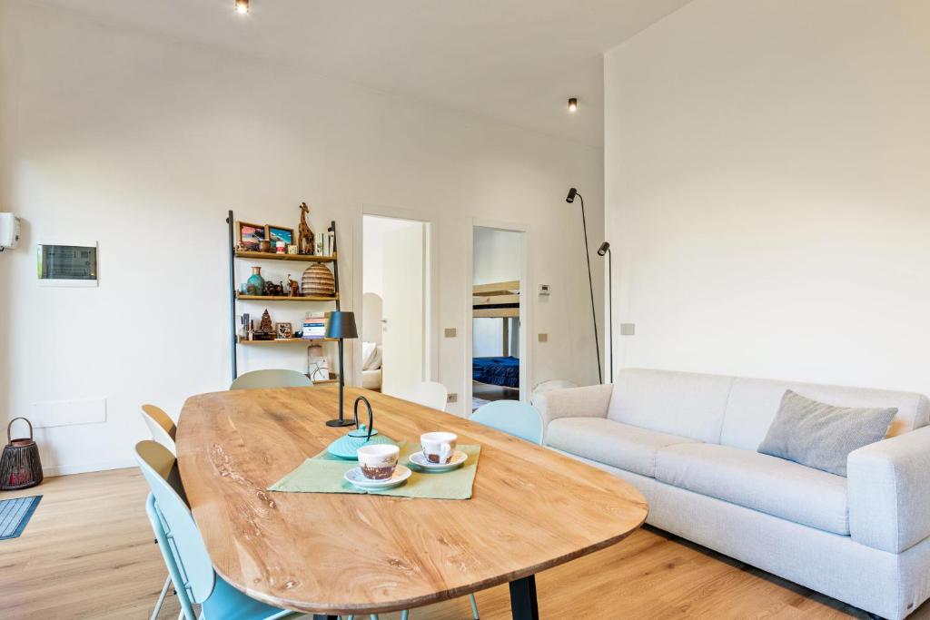 a living room with a wooden table and a couch at Lakefront apartment with terrace near Como in Montorfano