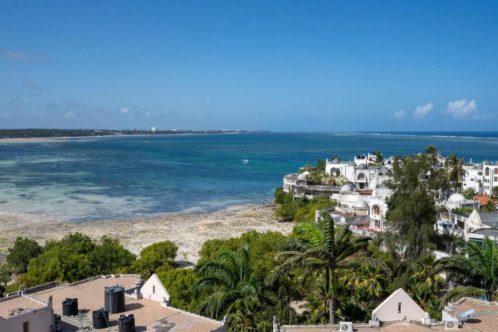 an aerial view of a beach with houses and trees at Ocean Cliff Homes 4 bedroom shared apartment in Mombasa