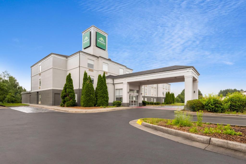 a large white building with a clock tower at Wingate by Wyndham Dublin Near Claytor Lake State Park in Dublin