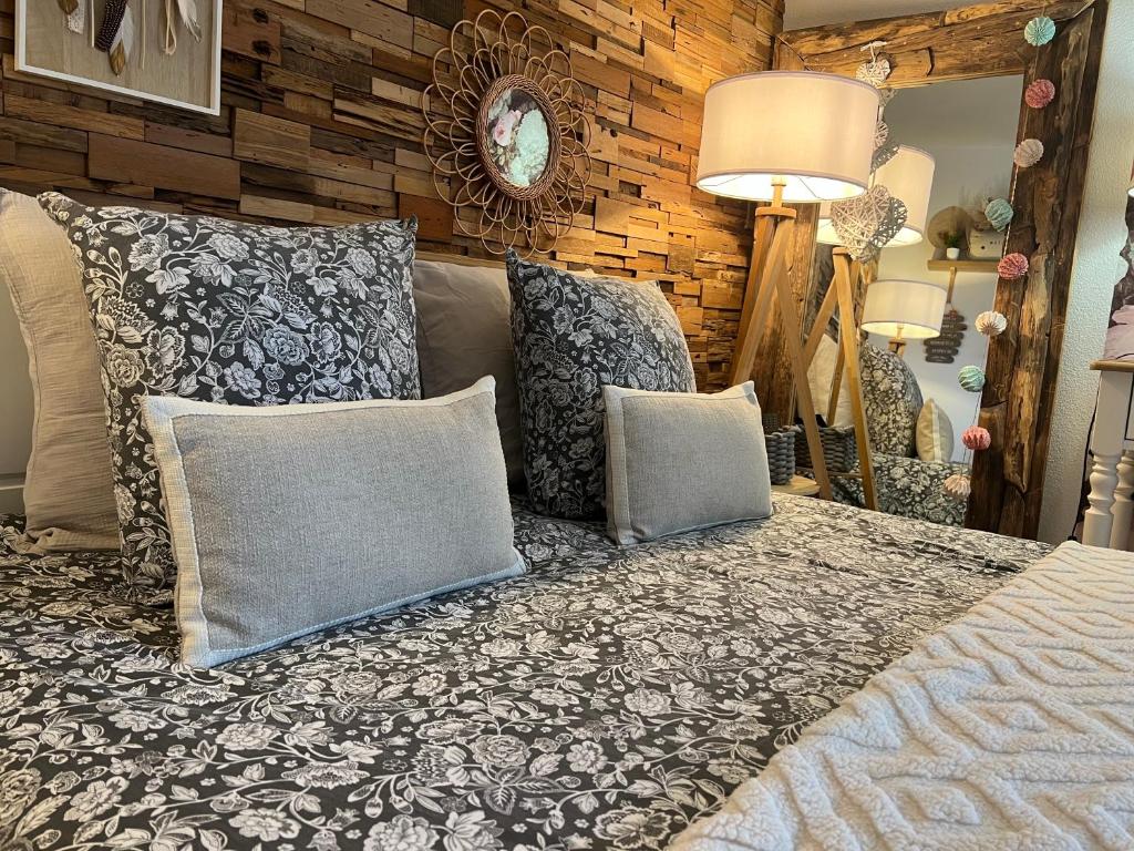 a bedroom with a bed with pillows on it at Petit cocon proche de Stanislas in Nancy