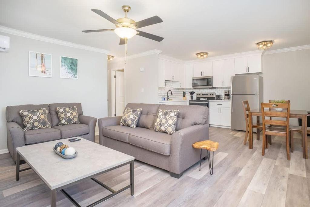 a living room with a couch and a table at Hillside Cove - Plank Suite Sleeps 4 in Bay View Beach