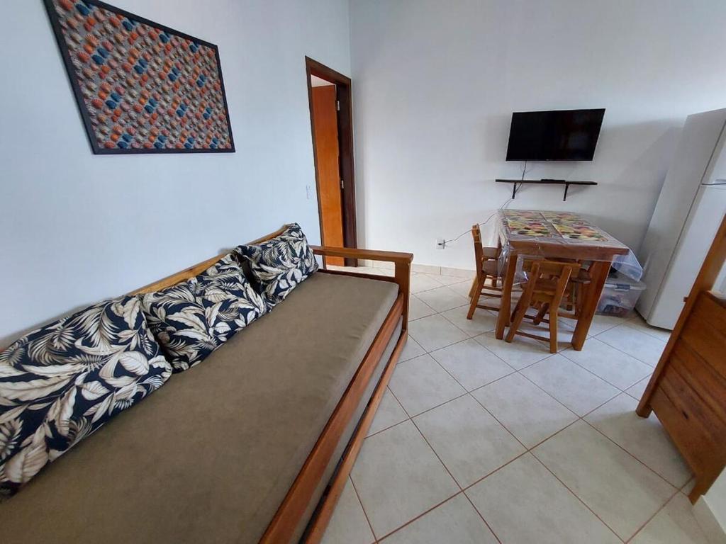 a living room with a couch and a table at Flat Beira Mar in Ilha Comprida