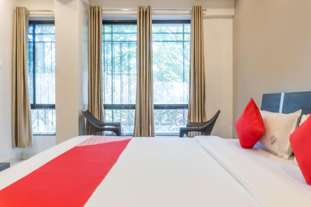 Ένα ή περισσότερα κρεβάτια σε δωμάτιο στο Hotel O Orchid Platinum Guest House