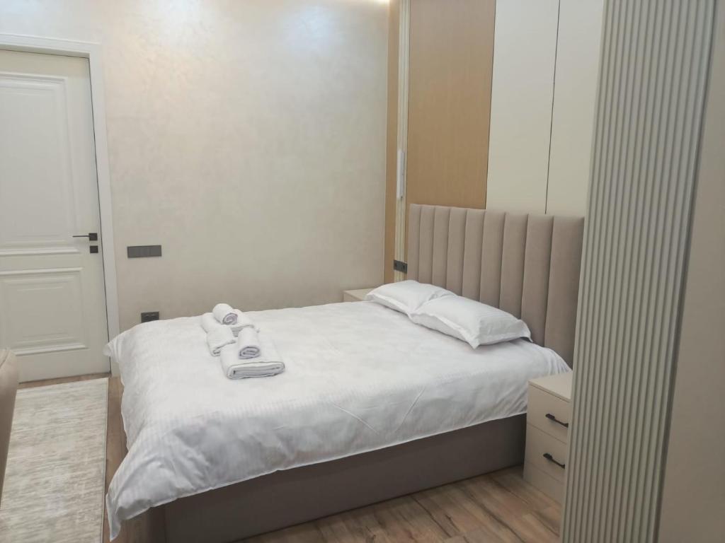 a small bedroom with a bed and a mirror at Уютная двух комнатная квартира возле Simketsity mall in Shymkent