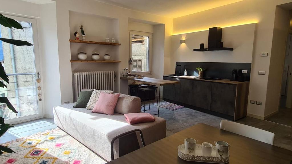 a living room with a couch and a table at Sandra House Berbenno in Berbenno di Valtellina