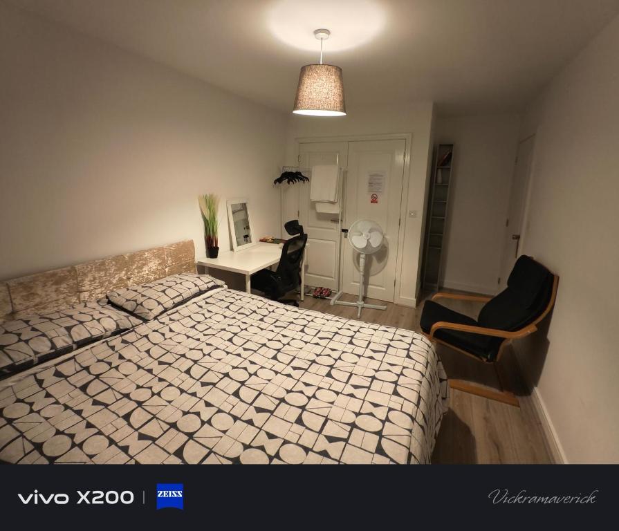 a bedroom with a bed and a desk and chairs at Free Car Park and walk to COOP, Etihad , Piccadilly,Free Snacks in Manchester