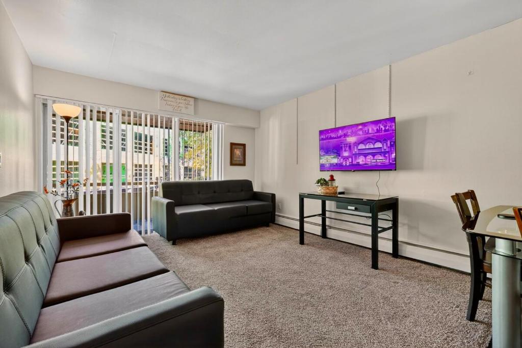 a living room with a couch and a table at Game Day Ready Walk to Big House, U-M Campus & UM Hospital in Ann Arbor