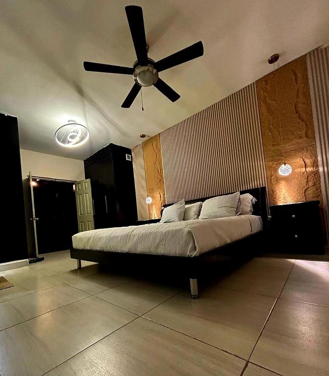a bedroom with a bed with a ceiling fan at Habitacion Olmo in Saltillo