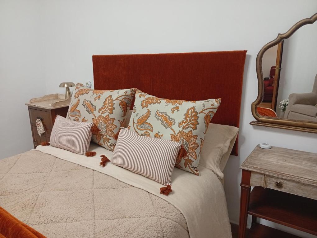 San Carlos del ValleにあるCasa Rural en San Carlos del Valle- Doña Gumersindaのベッド(枕2つ、鏡付)