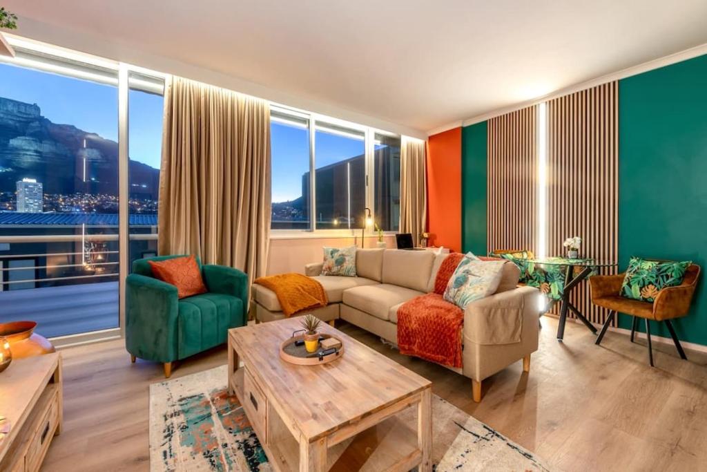 a living room with a couch and a table at Emerald Escape With Mountain View & Pool in Cape Town