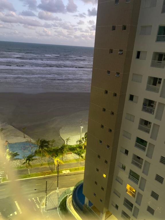 a view of the ocean from a building at Apartamento frente á praia - vista incrível e conforto in Praia Grande
