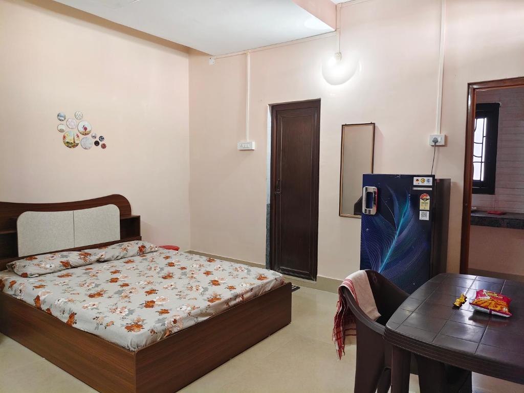 a bedroom with a bed and a table at JM Niwas in Guwahati