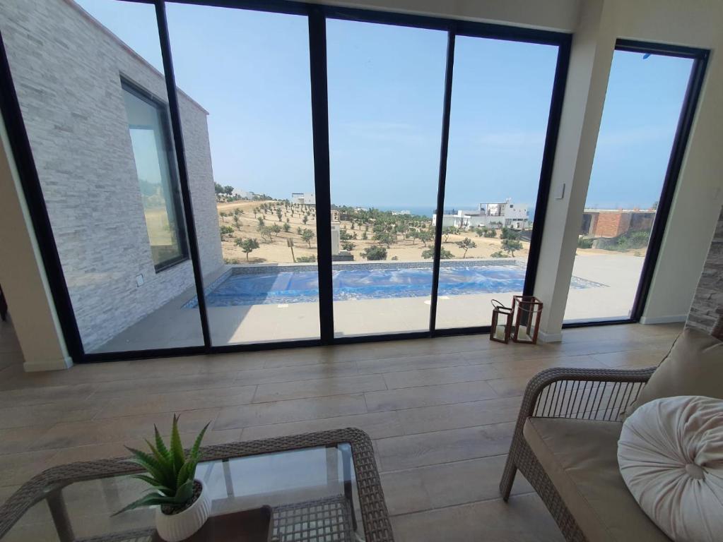 a living room with a view of a pool at CASA PLAYA con PISCINA in Punta Negra