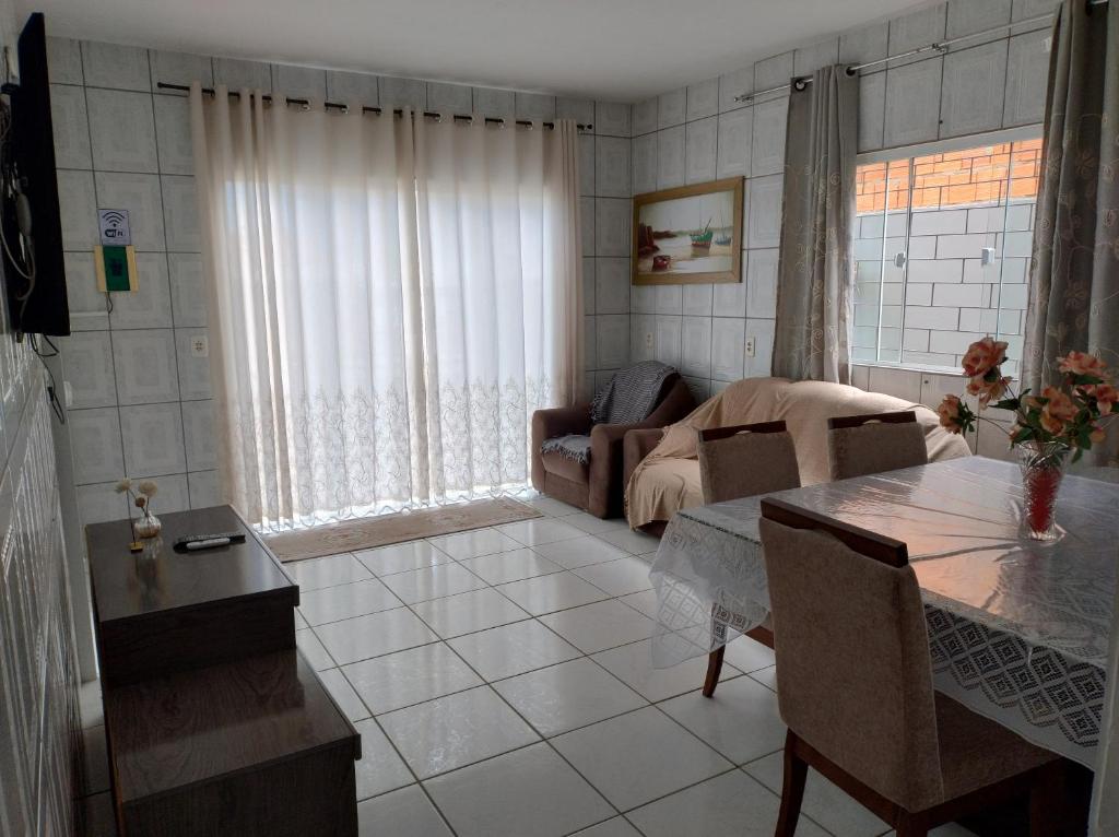 a living room with a couch and a table at Casa na praia Ubatuba Enseada in São Francisco do Sul