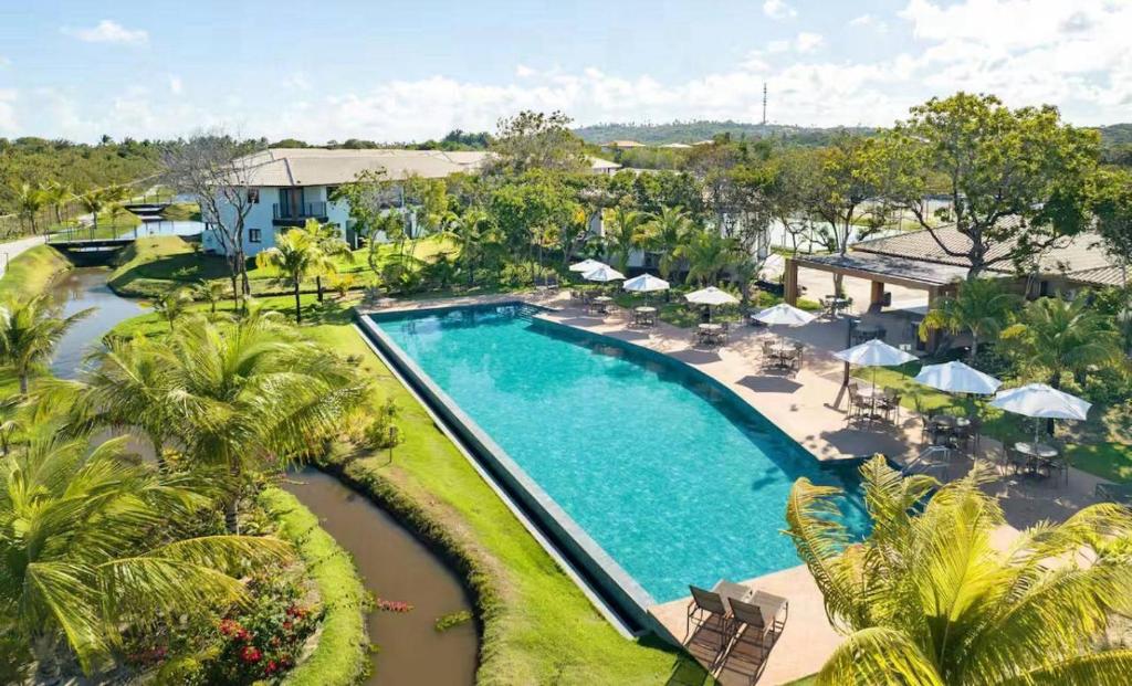 an aerial view of a pool at a resort at Studio lindíssimo Vila do Lago- 900m da vila in Praia do Forte