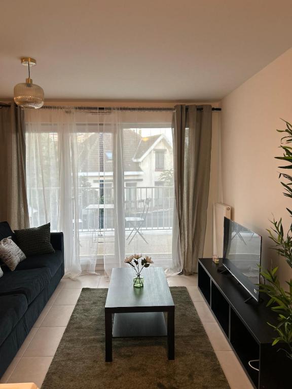 ein Wohnzimmer mit einer Couch und einem Couchtisch in der Unterkunft Chic 2 chambres appartement proche de Paris in Vitry-sur-Seine