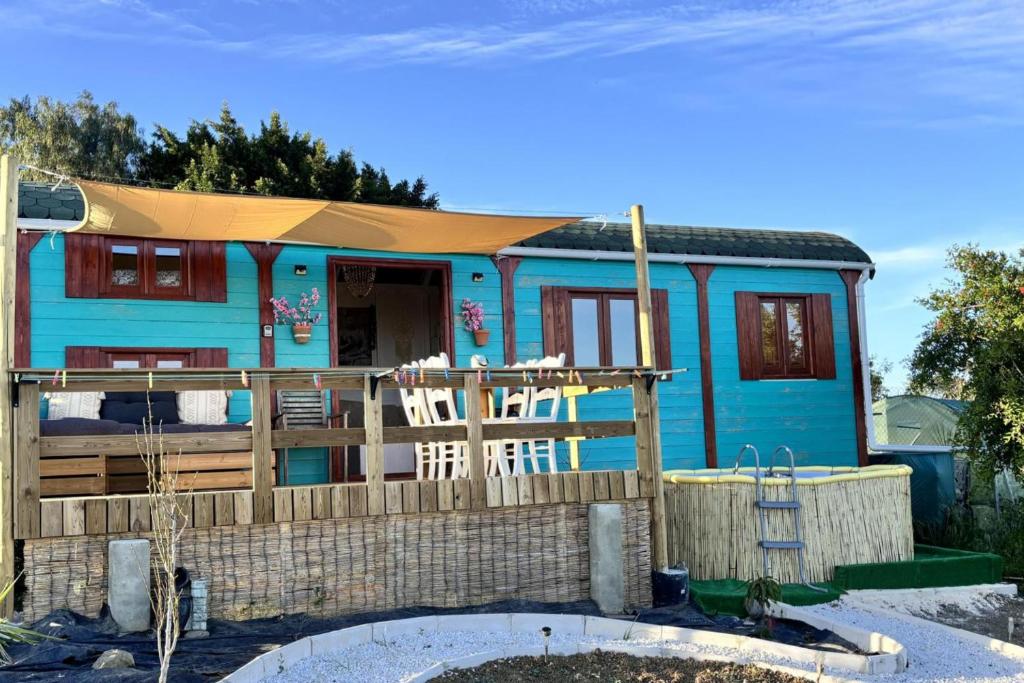 a blue house with a fence in front of it at Chalet Sleeps 2 - Pool Balcony Mountain Views in Estepona