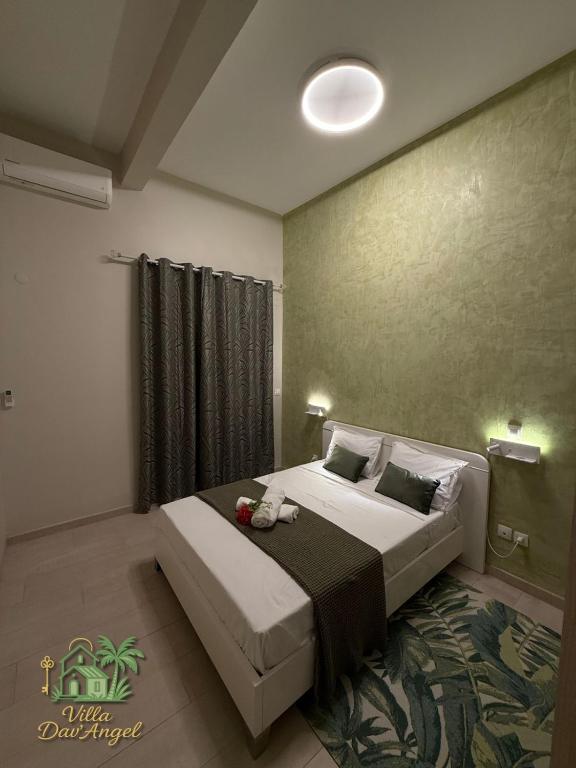 a bedroom with a large bed in a room at Villa DAV'ANGEL in Le Lamentin