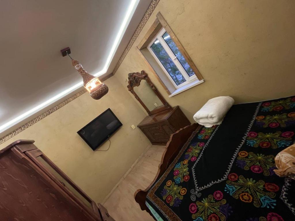 an overhead view of a bedroom with a bed and a television at Old City Butik Hotel in Tashkent