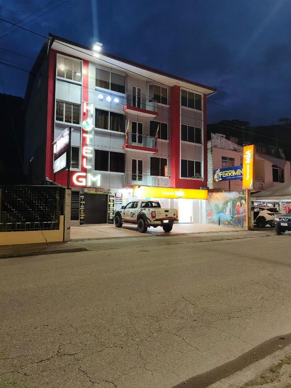 a white truck parked in front of a building at Hotel GM zamora Balcony in Zamora